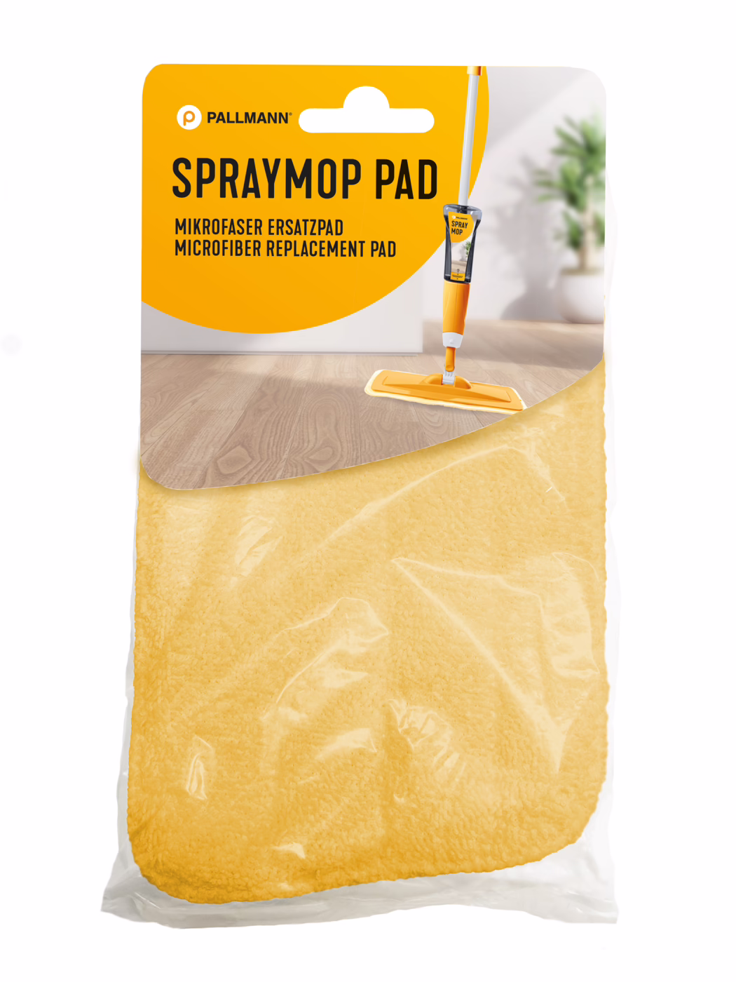 Retail-packaged yellow microfibre replacement pad for a Pallmann spray mop. The orange-and-white header reads 'SPRAYMOP PAD' and features an image of an orange spray mop on a wooden floor; the yellow microfibre pad is visible through clear plastic. Bright, tidy indoor setting with a blurred potted plant in the background.